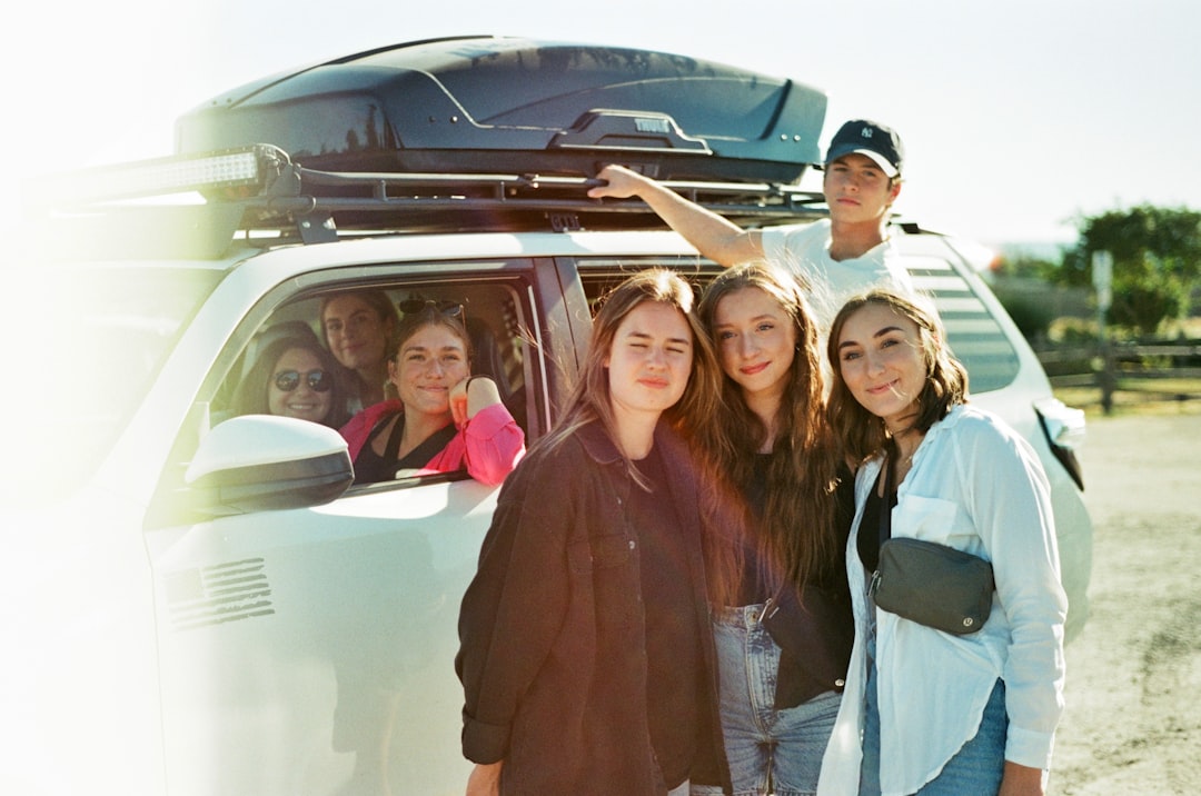 a group of people standing in front of a van