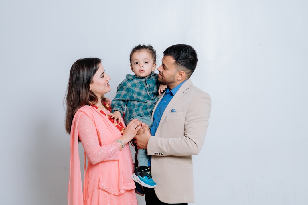 A man and woman holding a small child