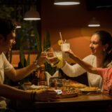 three people having a toast on table