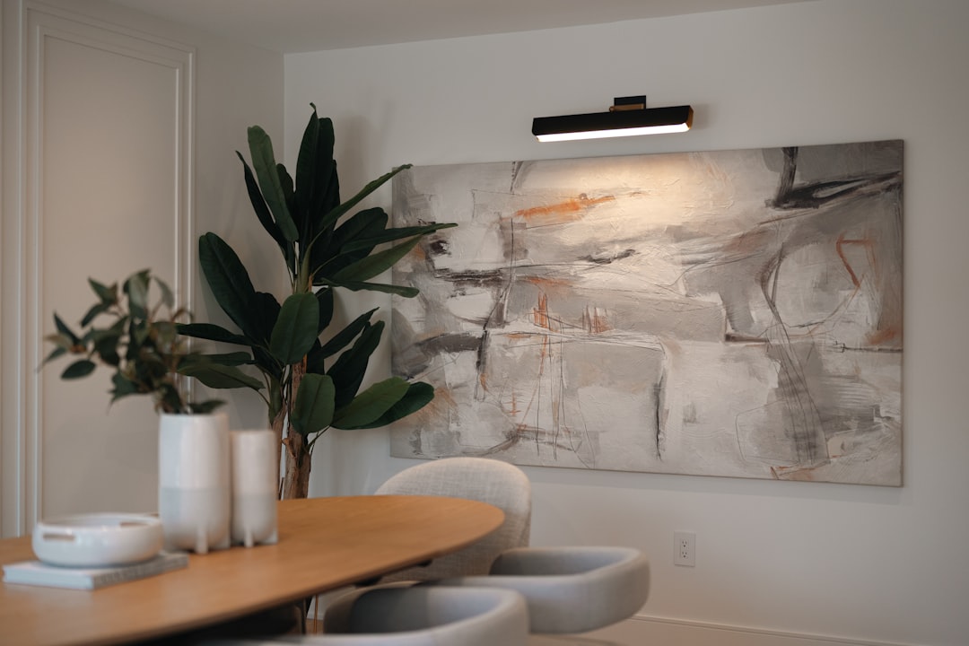 Modern dining room with abstract art and large plant