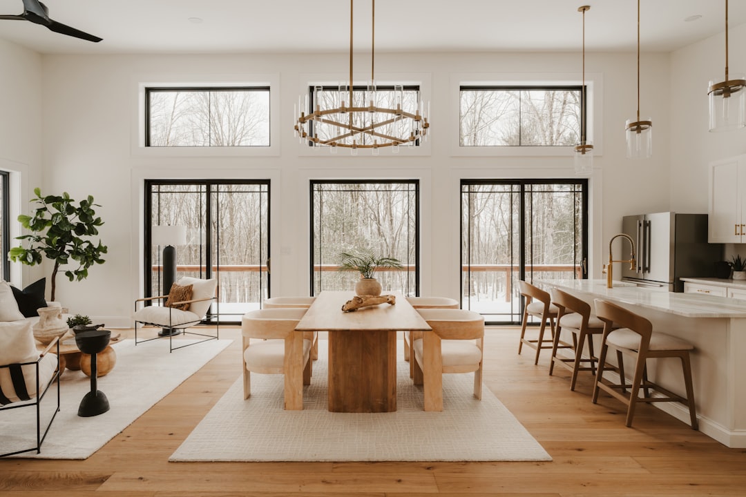 Modern dining and living area with large windows.