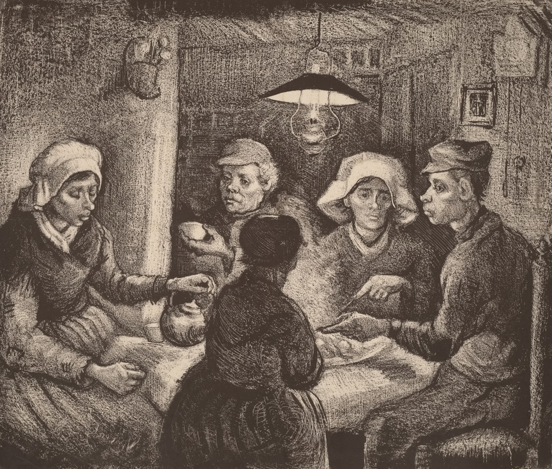 People gathered around a table under a lamp.