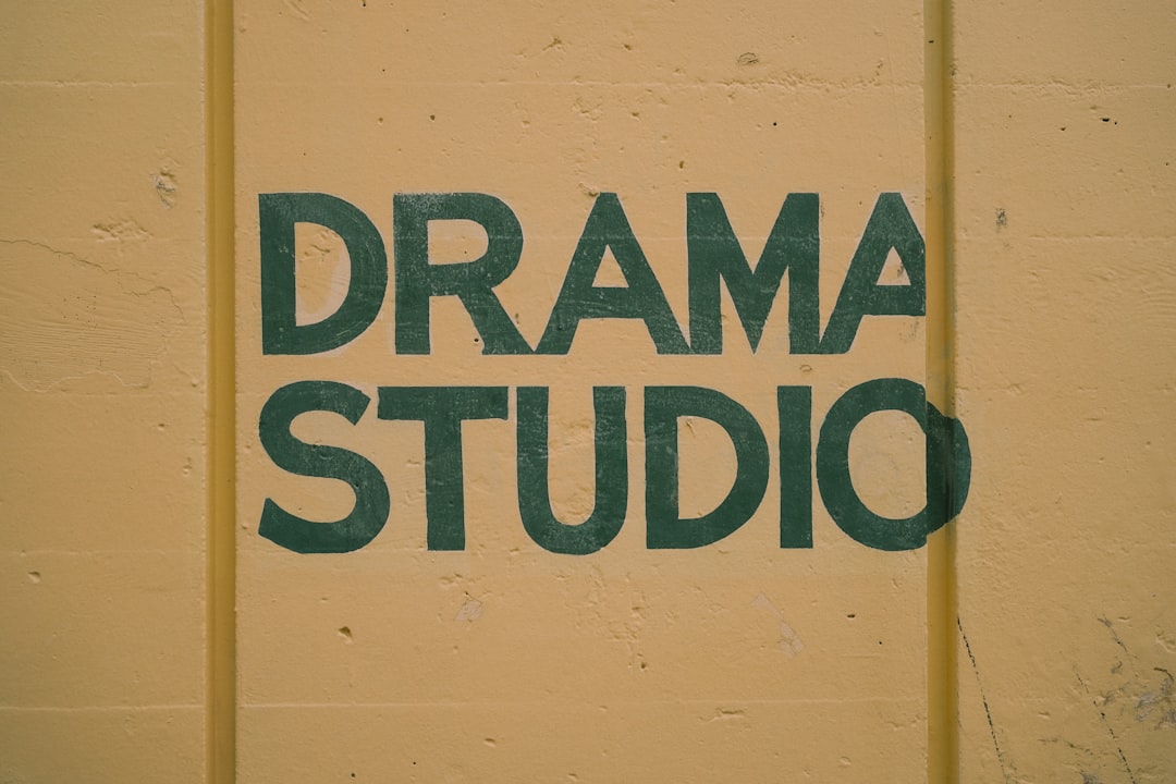 a sign that says drama studio painted on a wall