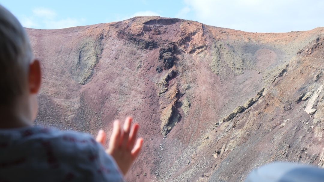 Child looking at a colorful volcanic crater