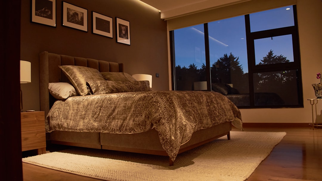 a bedroom with a large bed and a large window