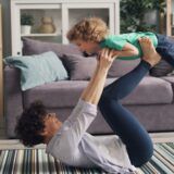 a woman is holding a child in the air