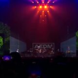 Acda en de Munnik op een podium met groene bomen en lichtshow tijdens een reünieconcert